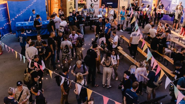 A group of hackers gather outside in the Factory Berlin community space.