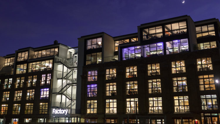 An exterior photograph of Factory Berlin Mitte at night.