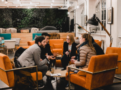 Community startup team talking in the Factory Berlin Görlitzer Park Cafe.