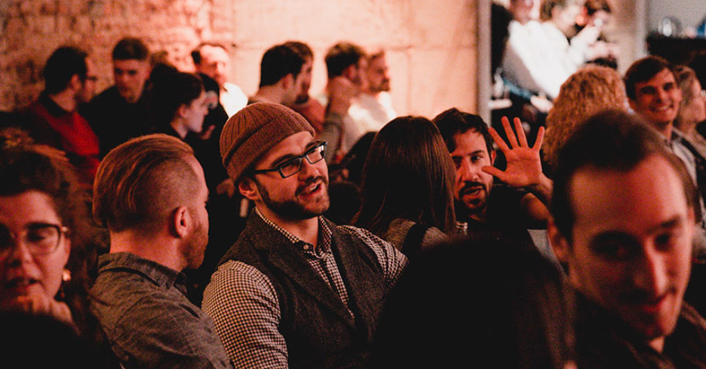 Guests in the audience at a Factory Berlin event are talking to each other.